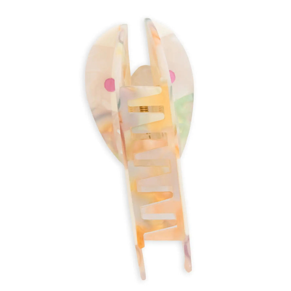 A translucent claw hair clip with a translucent body, set against a plain white background.