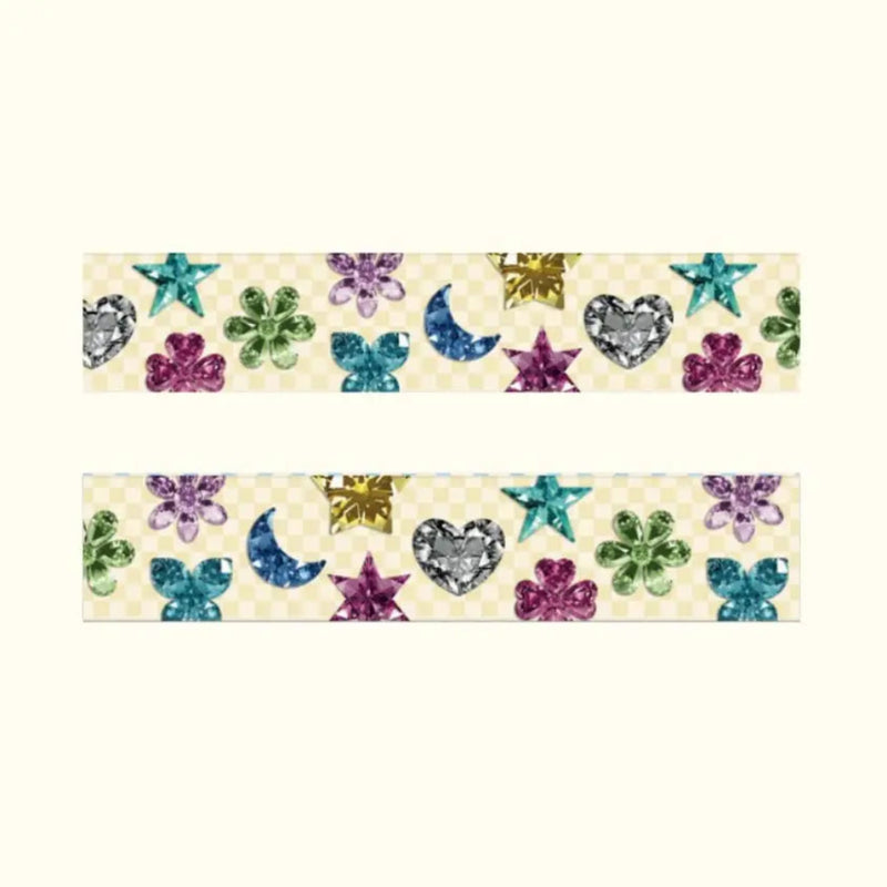 Decorative washi tape with gemmy hearts, flowers, and moons on a beige background