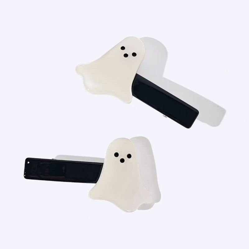 Two ghost-shaped hair clips with black metal bars, shown on a plain light background.