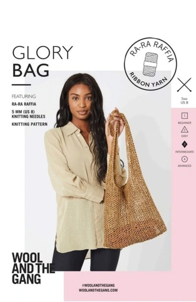 Model in tan button down top and black jeans holding a brown knitted shoulder bag, on a white and pink background with Wool & the Gang branding and text.