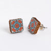Square floral patterned granny square earrings on a white background
