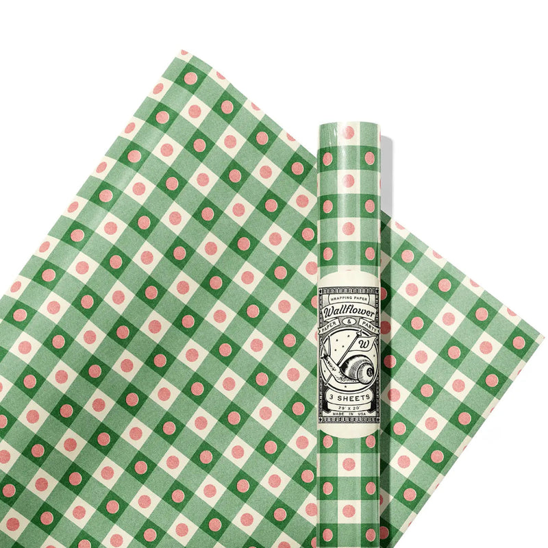 Green and pink polka dot and checkered patterned paper with a brand label on a white background
