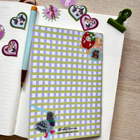 Notebook with decorative stickers on a wooden surface