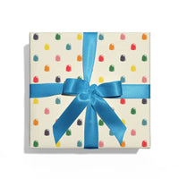 Gift box with colorful gumdrop pattern and blue ribbon on a white background