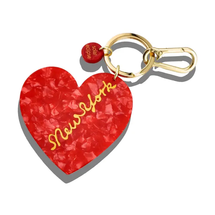 Red heart-shaped charm attached to a gold keychain ring.