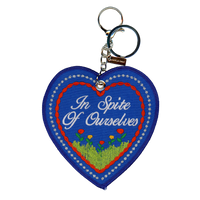 Blue embroidered heart that reads "in spire of ourselves," attached to a silver key ring.