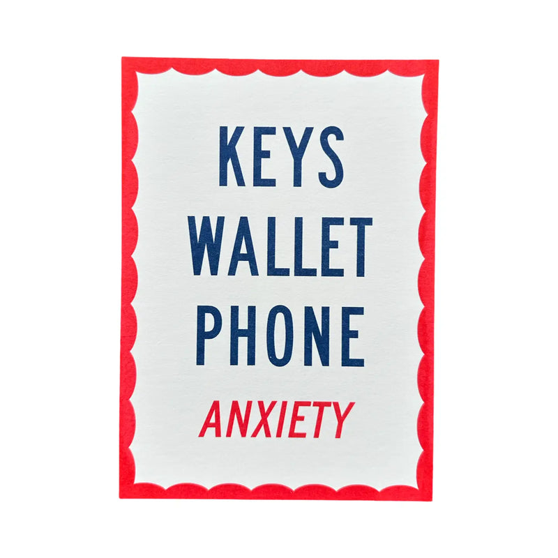 White sign with red border listing 'Keys', 'Wallet', 'Phone', and 'Anxiety' in blue and red text.