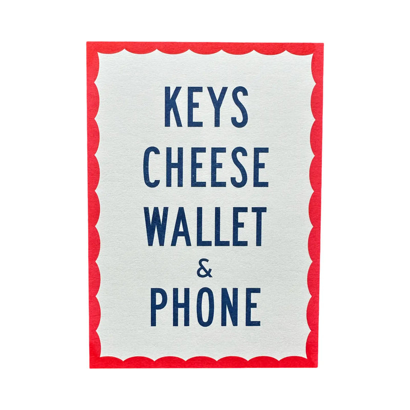 White sign with red border listing 'Keys', 'Cheese', 'Wallet', and 'Phone' in blue text.