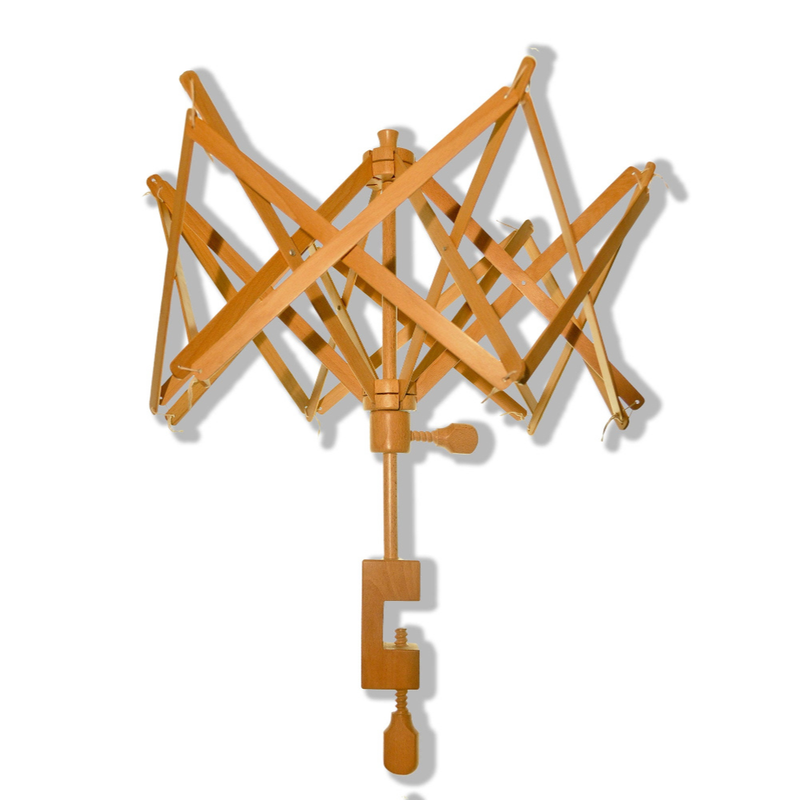 A wooden folding yarn swift with an accordion-style crisscross design and a central clamp at the bottom, shown on a plain white background.