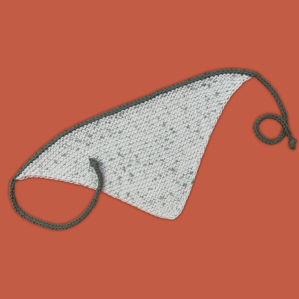 Knitted bandana with green tie on an orange background