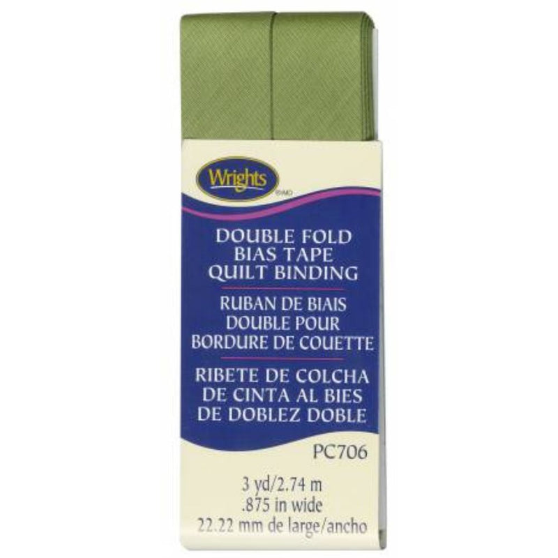 Box of Wright's double fold bias tape quilt binding with green fabric sample on a white background