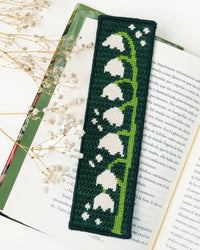 Needlepoint bookmark with white flower pattern on an open book