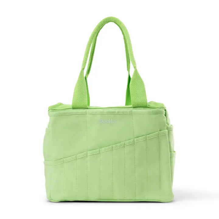 Green tote bag with multiple pockets on a white background