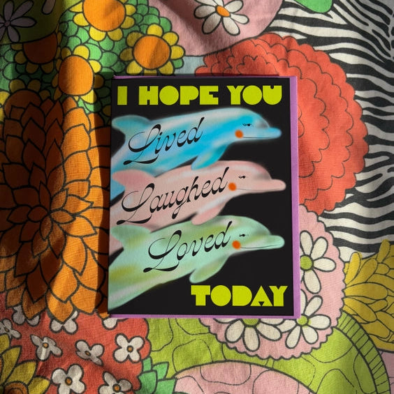 Black card with airbrushed dolphins. 'I hope you Live Laughed Loved Today'