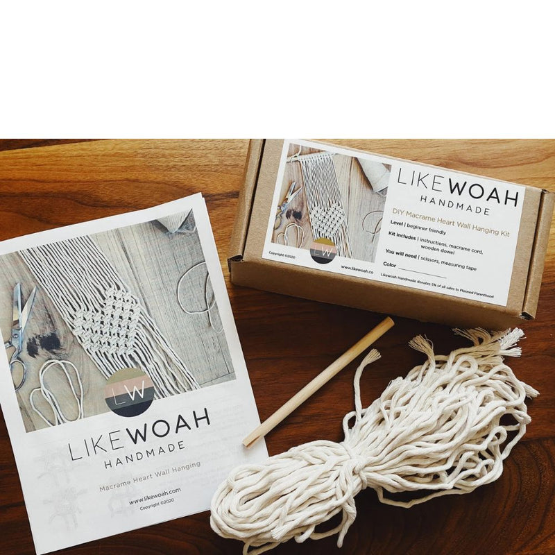 Macrame heart wall hanging kit with materials and instructions on a wooden surface, featuring LIKEWOAH Handmade branding.