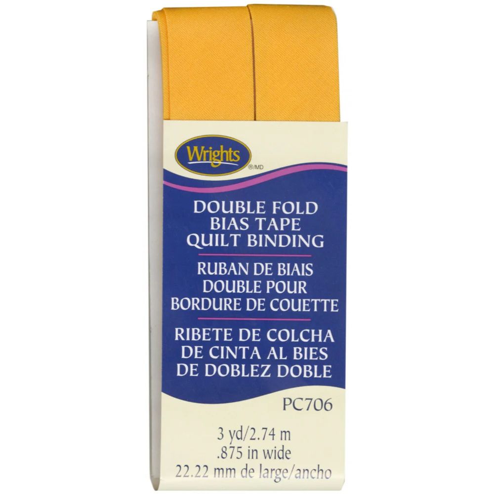 Box of Wrights double fold bias tape quilt binding with yellow fabric sample on a white background