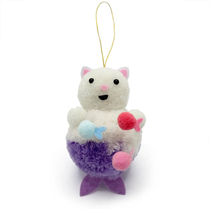 White mermaid cat with a purple tail holding three fish pom pom ornament on a white background.
