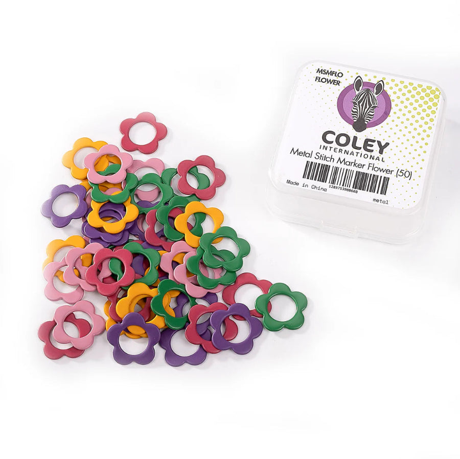 A pile of flower shaped metal ring markers in pink, purple, yellow, and green, next to a small plastic carrying case