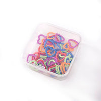 Small plastic case full of metal heart stitch markers in assorted colors