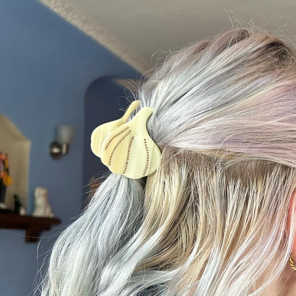 Garlic-shaped hair claw, clipped into blonde hair.