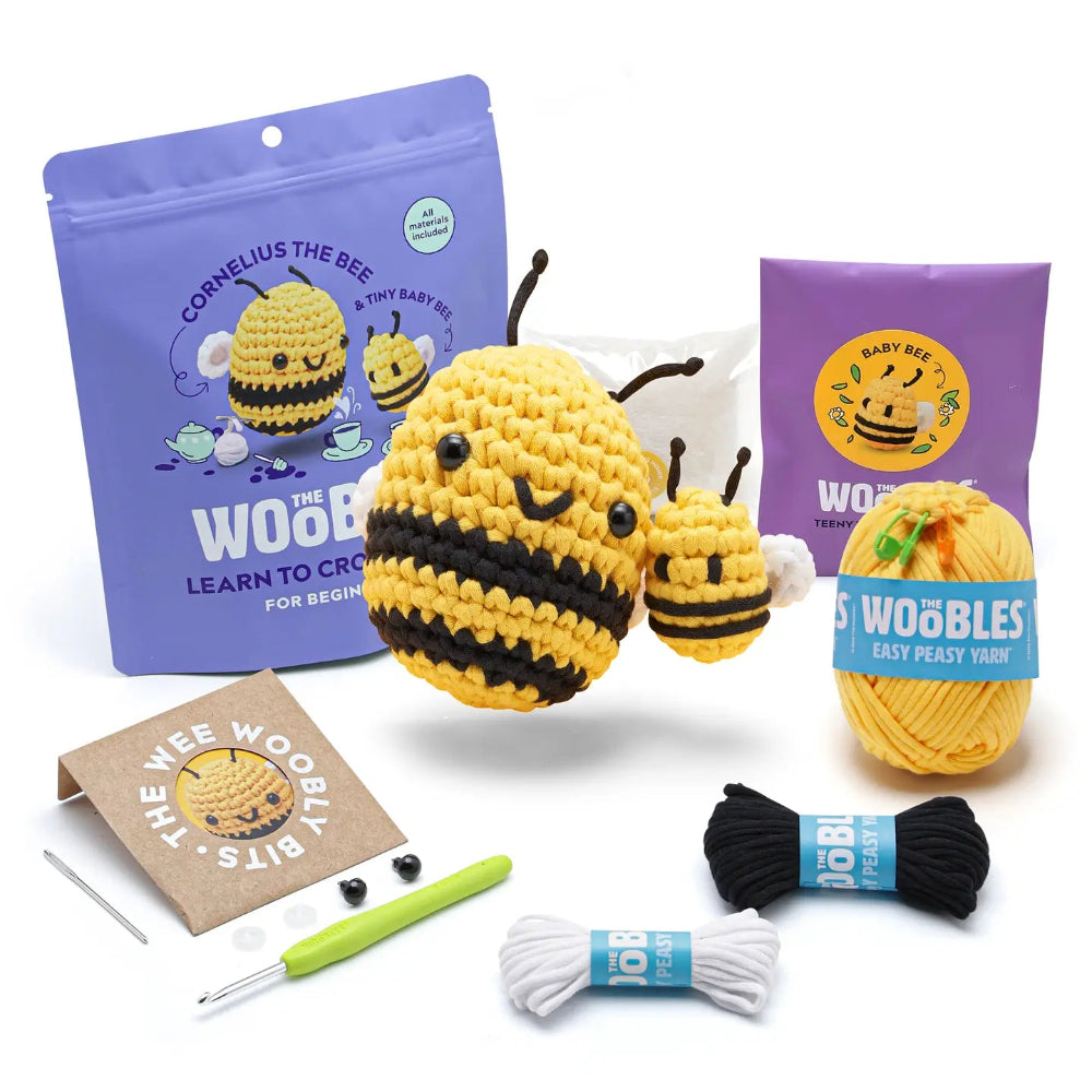 Crochet bee kit with yarn, hooks, and packaging on a white background