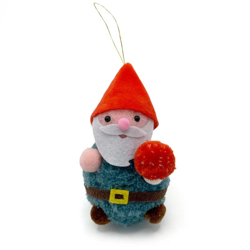 Gnome with a red hat holding a mushroom pom pom ornament on a white background.