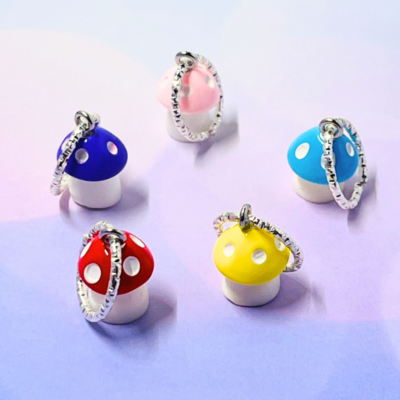 Five mushroom-shaped stitch markers, attached to a silver metal ring