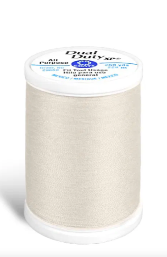 A spool of light beige/cream Dual Duty XP All Purpose sewing thread on a white background.