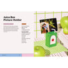 Juice box picture holder with green apples on a checkered tablecloth