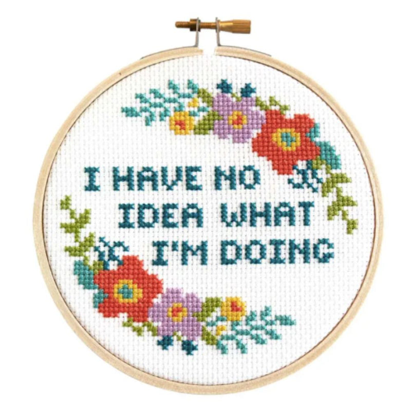 Cross-stitched hoop with colorful flowers and text 'I HAVE NO IDEA WHAT I'M DOING' on a white background