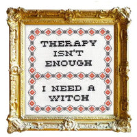 Decorative framed cross-stitch with text 'Therapy isn't enough, I need a witch' on a white background.