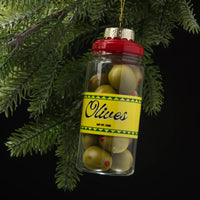 Decorative Christmas ornament shaped like a jar of olives hanging on a tree branch.