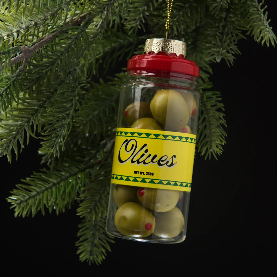 Decorative Christmas ornament shaped like a jar of olives hanging on a tree branch.