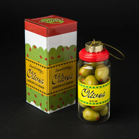 Ornament in the shape of a jar of olives with a red cap next to a box labeled 'Olives'.