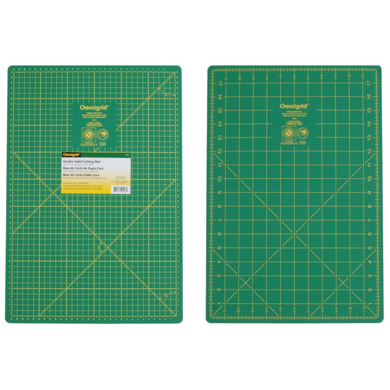 Two green cutting mats with grid lines on a white background