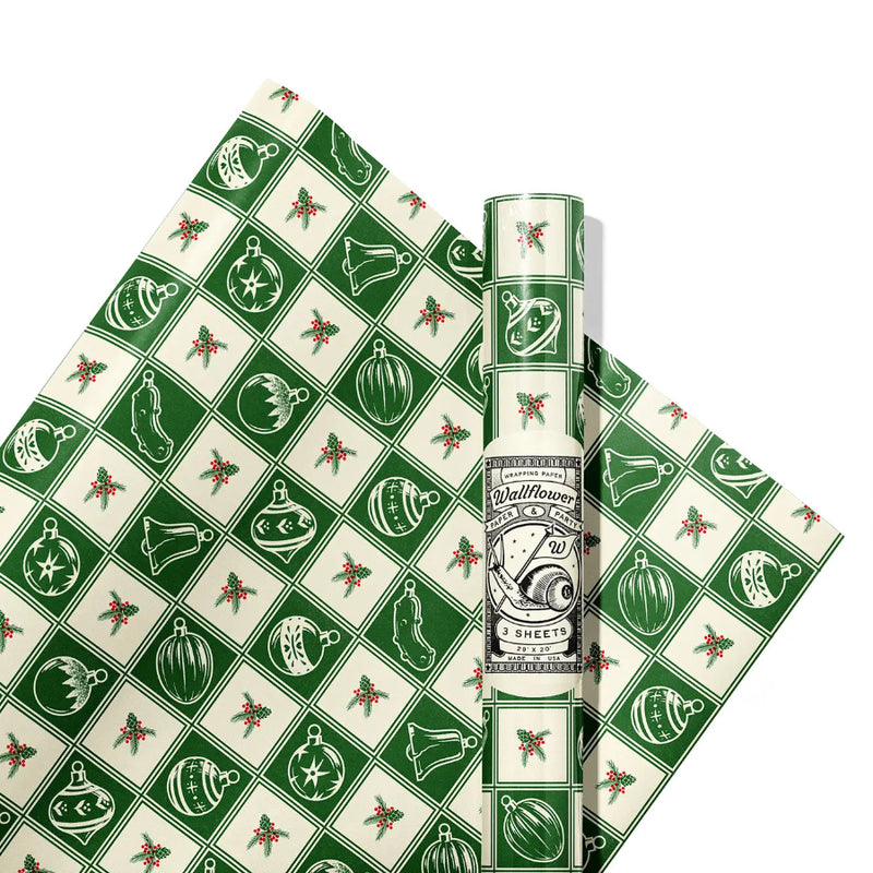 Green and white patterned gift wrap with ornaments on it on a white background.