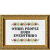 Cross-stitched text 'OTHER PEOPLE RUIN EVERYTHING' with decorative elements in a gold frame.