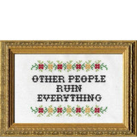 Cross-stitched text 'OTHER PEOPLE RUIN EVERYTHING' with decorative elements in a gold frame.