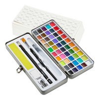 A set of 69 differently colored watercolor paint pans inside a white and black metal case, including 2 brushes, a pencil, eraser, sharpener, sponge, and sheets of watercolor paper.