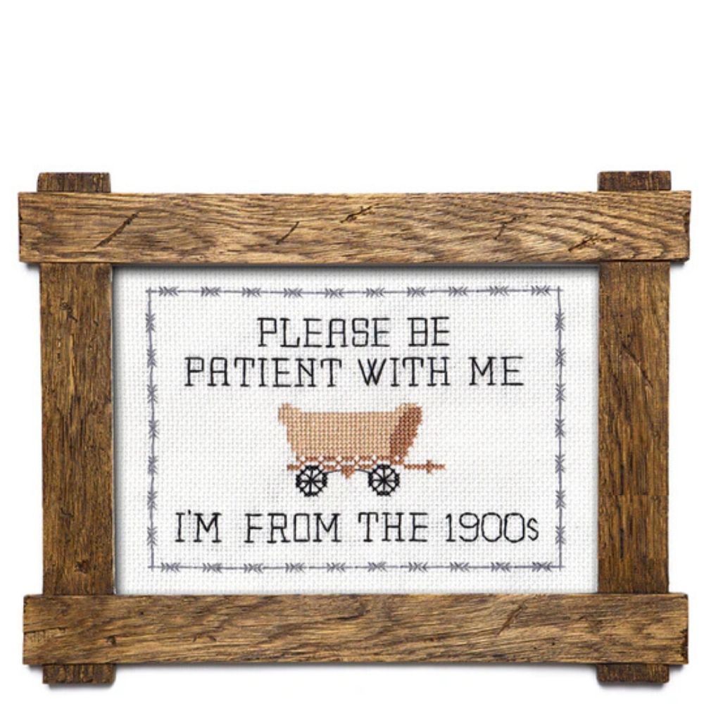 Decorative sign with a wooden frame, featuring text and a vintage-style illustration of a covered wagon.