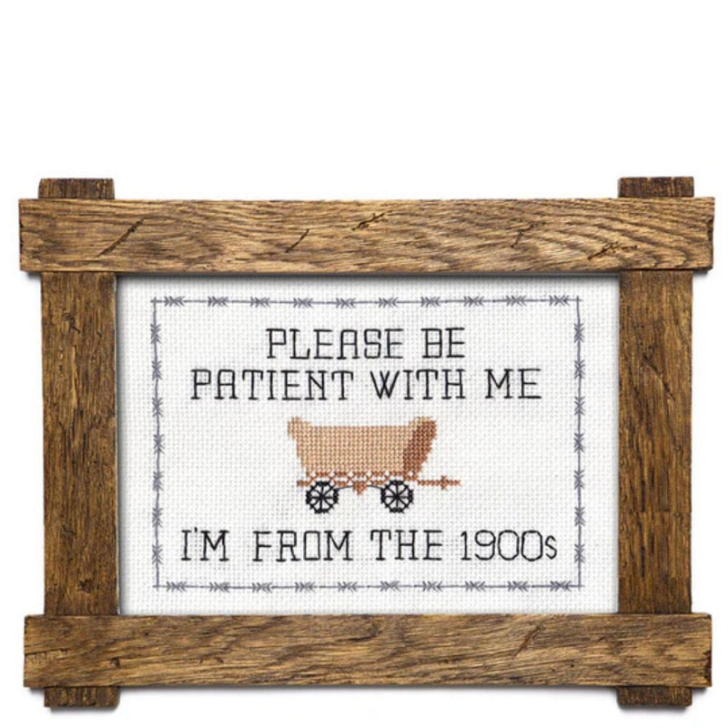 Decorative sign with a wooden frame, featuring text and a vintage-style illustration of a covered wagon.