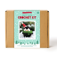 Crochet kit packaging with a penguin design on a white background