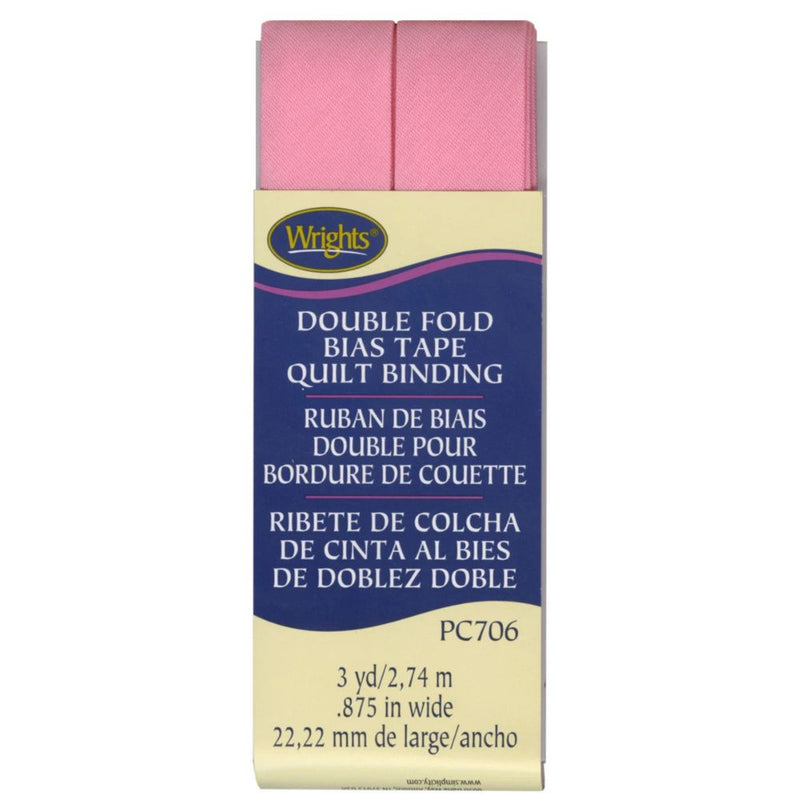 Packaged Wrights double fold bias tape quilt binding with pink tape on a white background