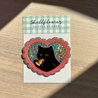 Glitter sticker with a black cat design on a wooden background