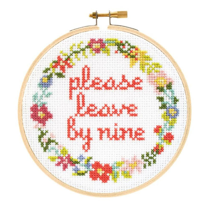 Cross-stitched hoop with floral design and text 'please leave by nine' on a white background
