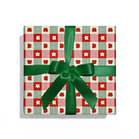Gift box with red and green checkered pattern and green ribbon on a white background