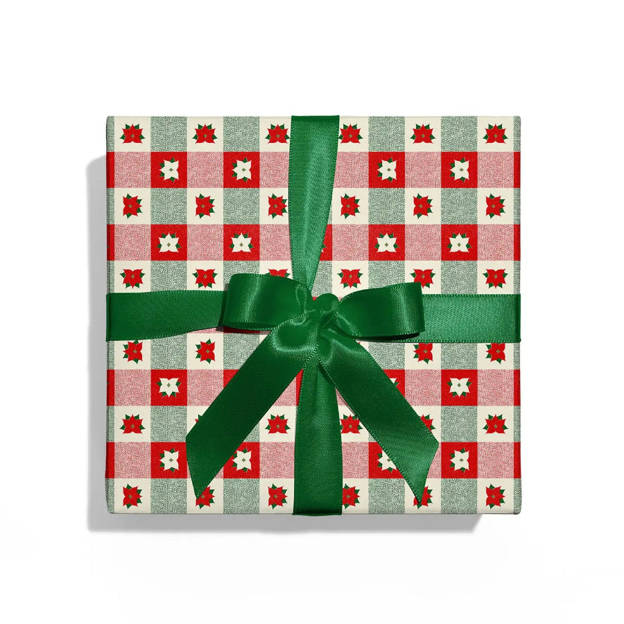 Gift box with red and green checkered pattern and green ribbon on a white background