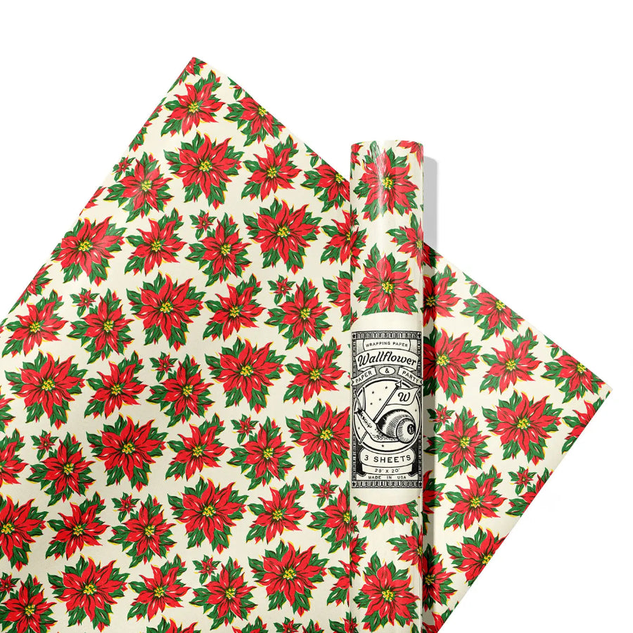 Red poinsettia patterned gift wrap with a visible brand label on a white background