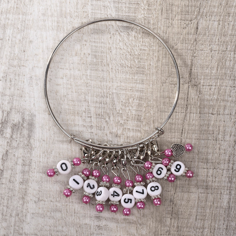Numbered progress keepers/ stitch markers (0-9) wirh pink beads on a silver metal bracelet
