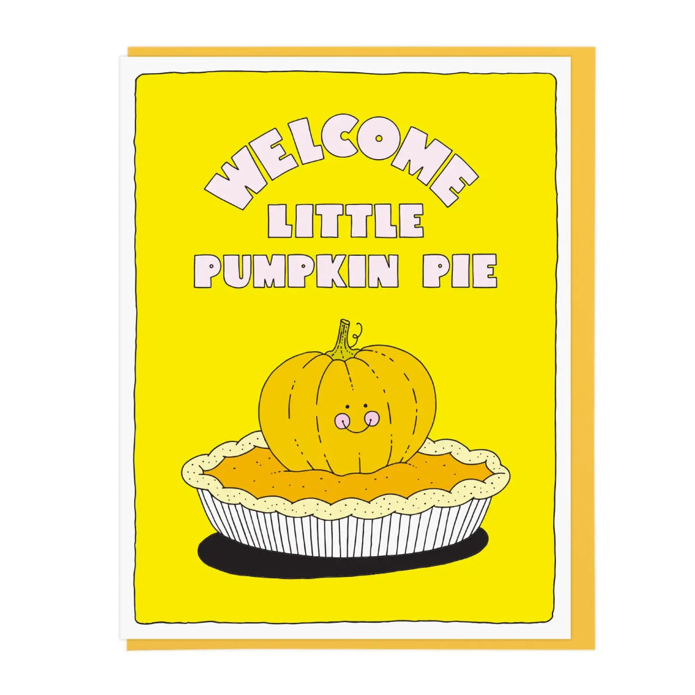 A greeting card with a bright yellow background and text saying 'WELCOME LITTLE PUMPKIN PIE' above a pumpkin atop a pumpkin pie pie illustration, shown with a tan envelope behind it on a white background.